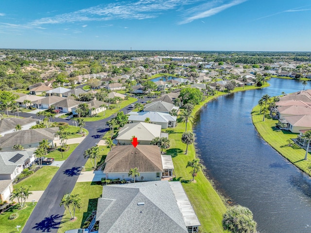 birds eye view of property with a water view and a residential view