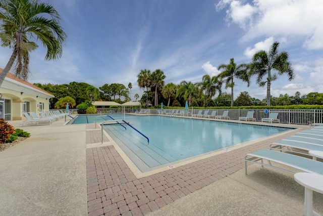 pool featuring a patio and fence