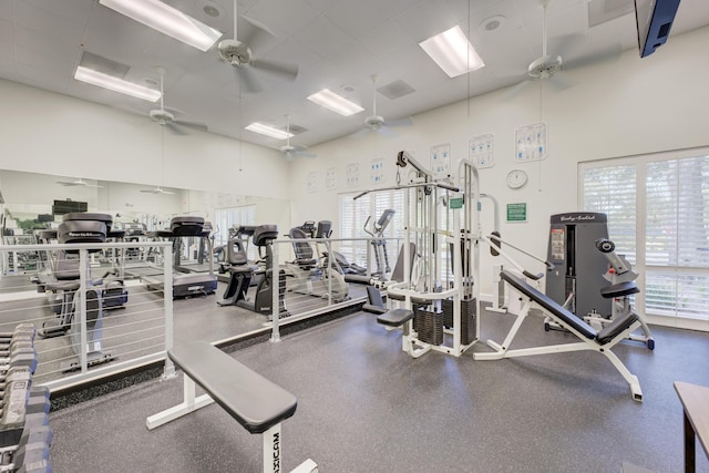 workout area with a high ceiling and a ceiling fan