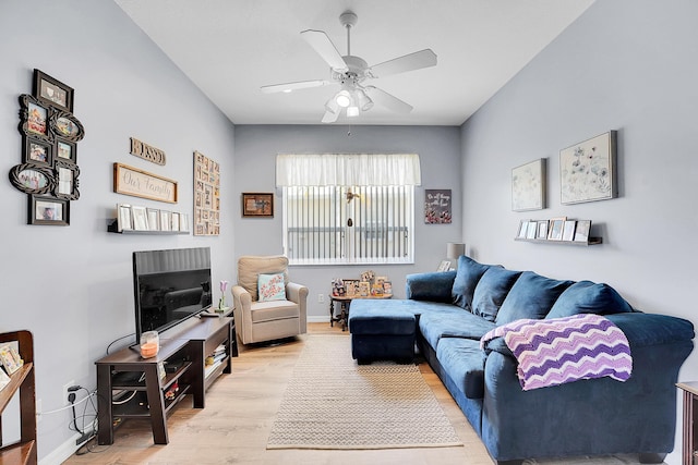 living room with ceiling fan, baseboards, and wood finished floors