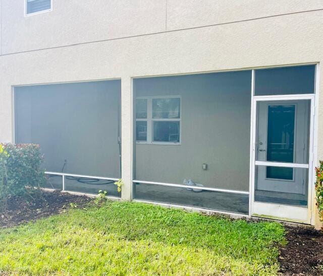 view of home's exterior featuring a yard and stucco siding