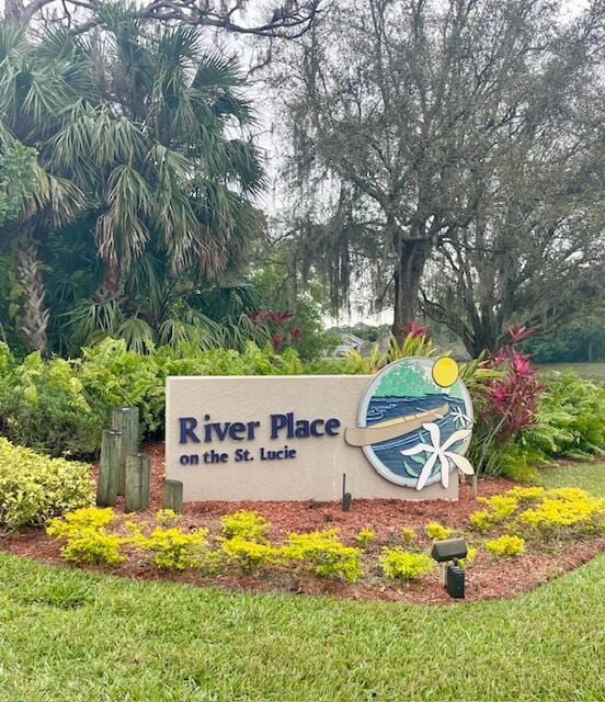 community / neighborhood sign with a lawn