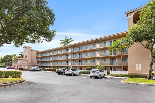 view of property featuring uncovered parking