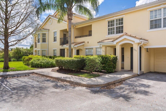 view of front of home with a tiled roof and stucco siding