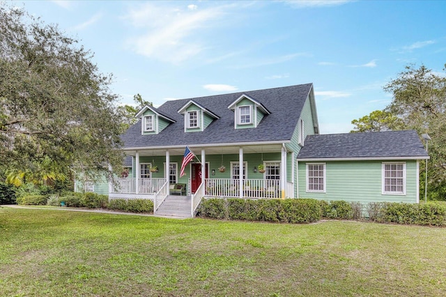 cape cod-style house with roof with shingles, a porch, and a front lawn