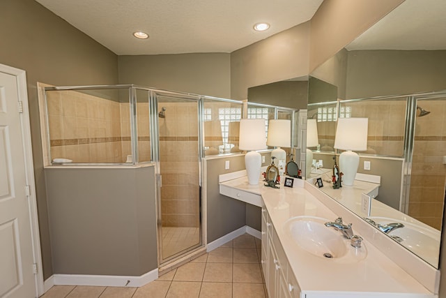 full bath with tile patterned floors, vanity, baseboards, and a stall shower
