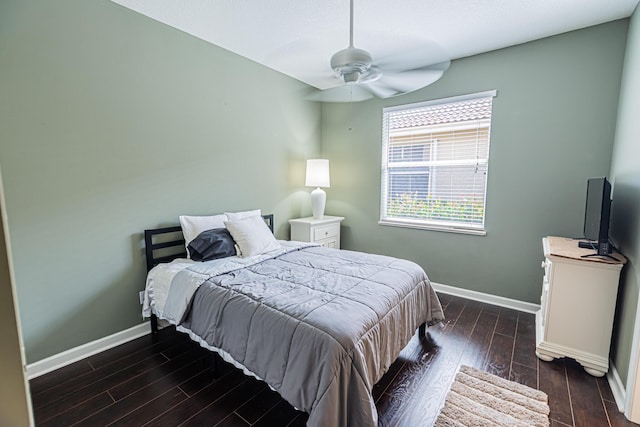 bedroom with dark wood-style flooring, baseboards, and a ceiling fan