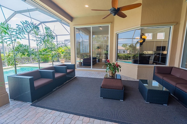 view of patio / terrace featuring an outdoor pool, a ceiling fan, an outdoor living space, and glass enclosure