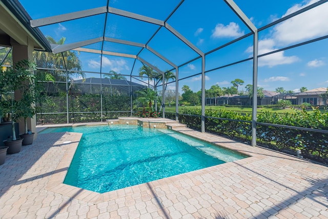 outdoor pool with a patio and glass enclosure