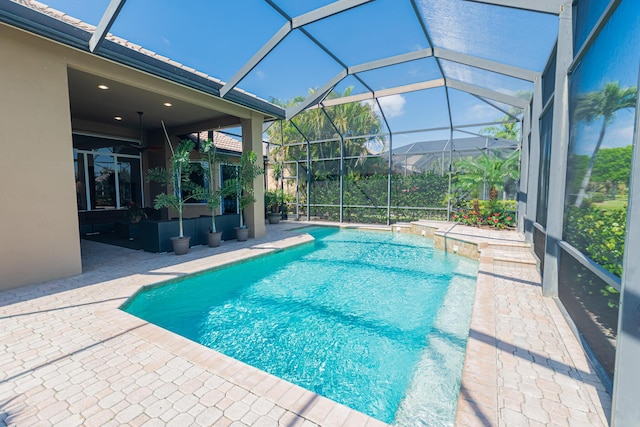outdoor pool with a lanai and a patio