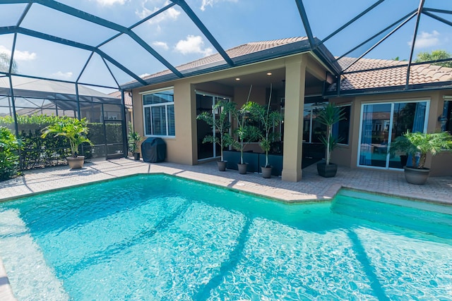 pool featuring a patio and glass enclosure