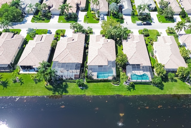 drone / aerial view with a water view and a residential view