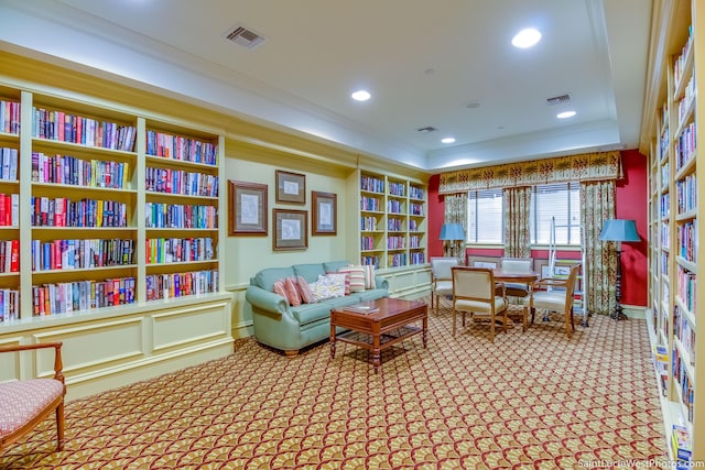 living area featuring carpet flooring, crown molding, visible vents, built in features, and recessed lighting
