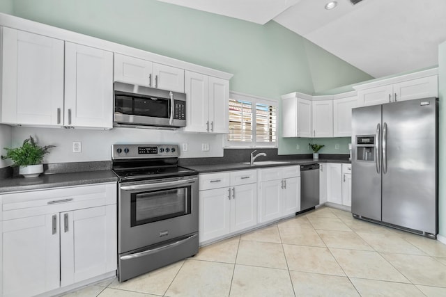 kitchen featuring light tile patterned floors, white cabinetry, stainless steel appliances, and a sink