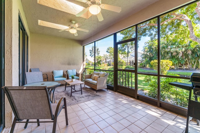 sunroom with a skylight and a ceiling fan