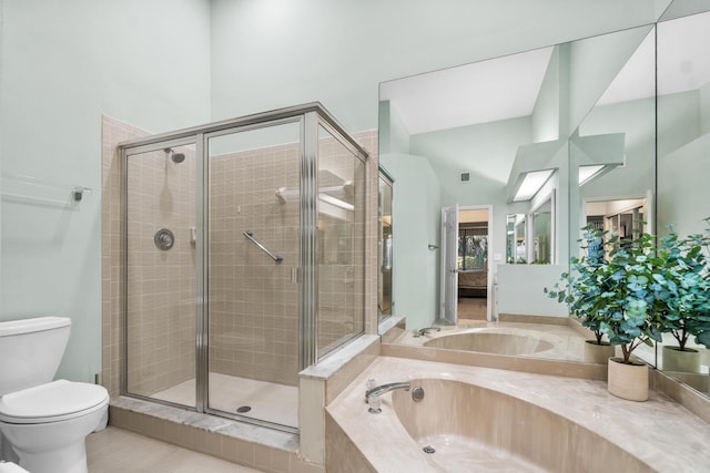 bathroom featuring a stall shower, a garden tub, and toilet