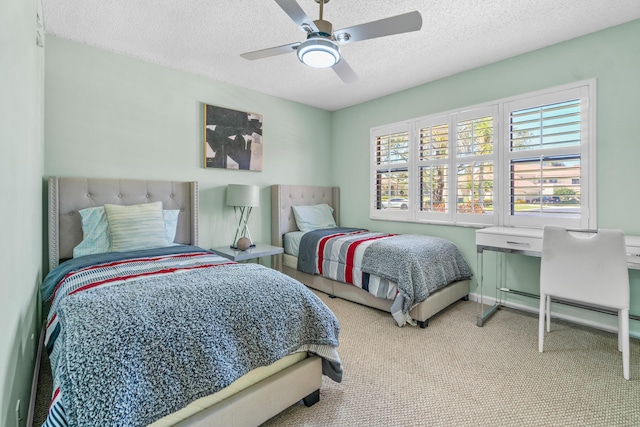 carpeted bedroom with a ceiling fan and a textured ceiling