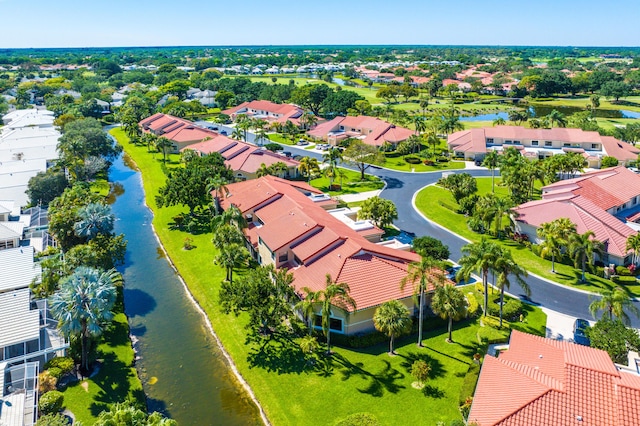 drone / aerial view featuring a residential view and a water view