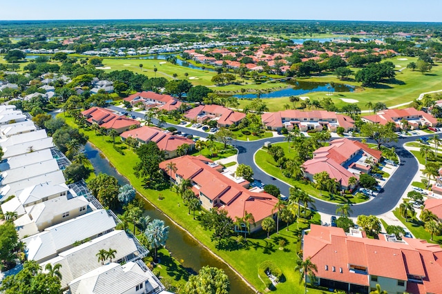 aerial view featuring golf course view, a water view, and a residential view