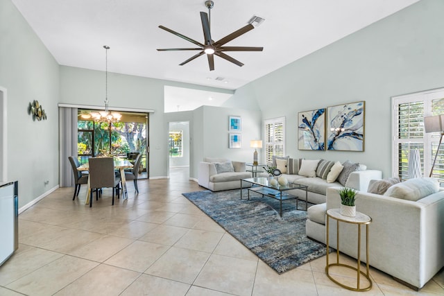 living room with light tile patterned floors, visible vents, high vaulted ceiling, and ceiling fan with notable chandelier