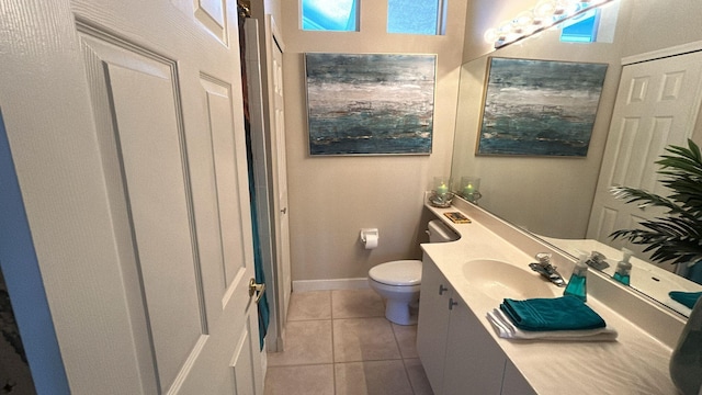 bathroom featuring vanity, tile patterned flooring, toilet, and baseboards