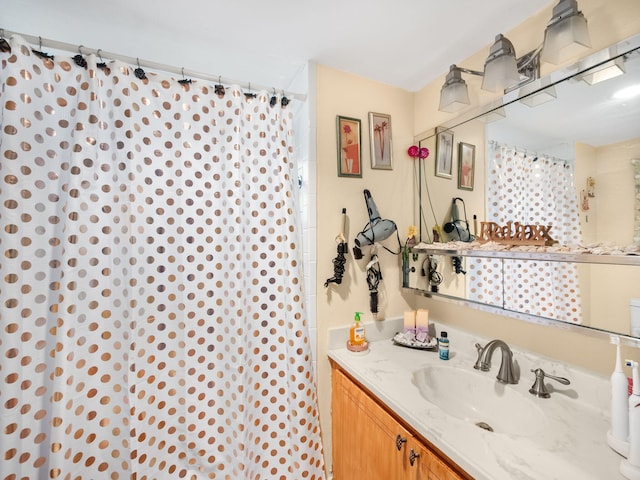 bathroom with curtained shower and vanity