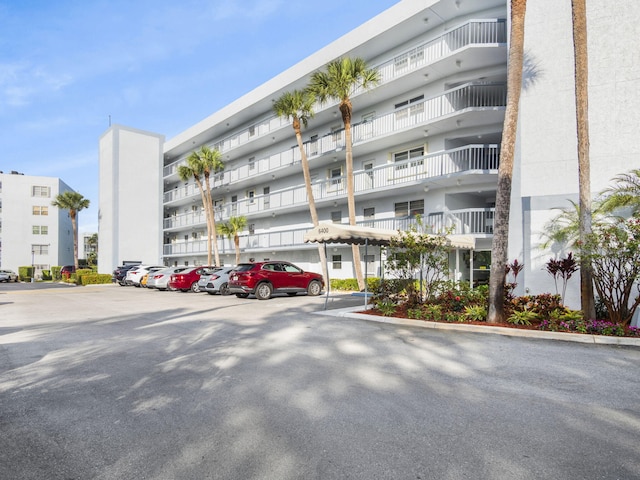 view of property featuring uncovered parking