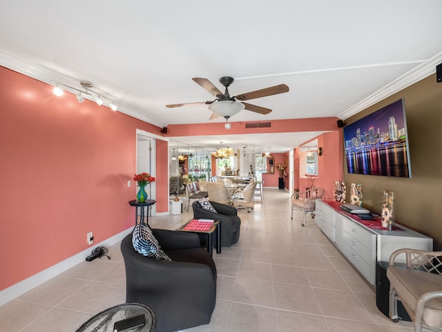 interior space featuring light tile patterned floors, ceiling fan with notable chandelier, visible vents, baseboards, and crown molding