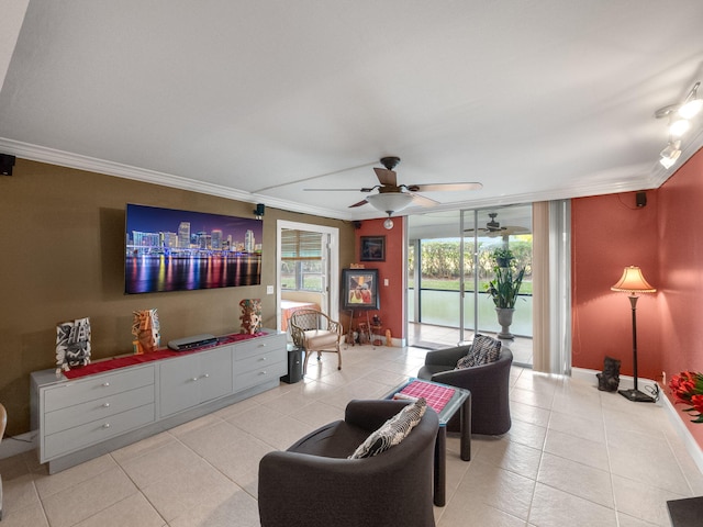 living room featuring ornamental molding, light tile patterned flooring, a ceiling fan, and baseboards