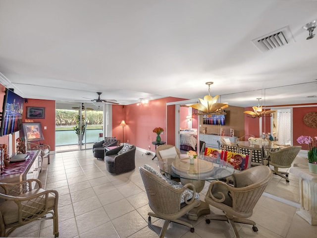 dining space with crown molding, light tile patterned floors, visible vents, baseboards, and ceiling fan with notable chandelier