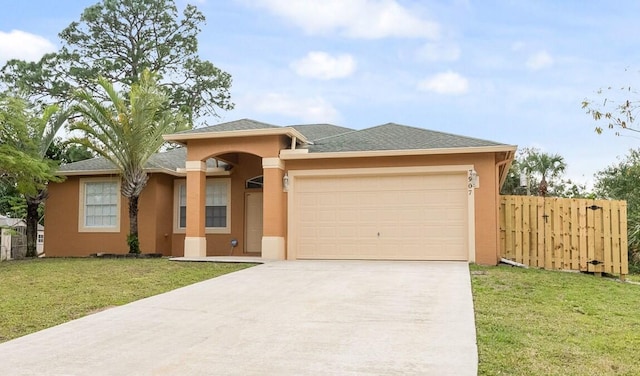 prairie-style house with a garage, fence, a front lawn, and stucco siding