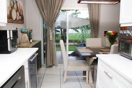 interior space featuring stainless steel appliances, light countertops, white cabinets, and light tile patterned floors