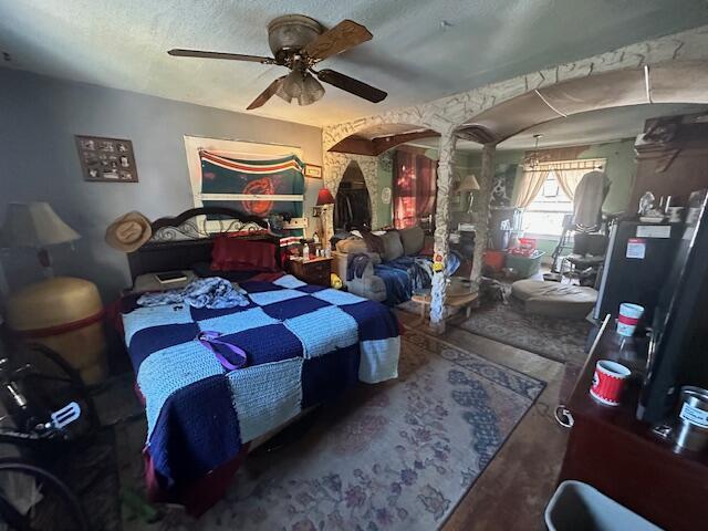 bedroom featuring a ceiling fan and a textured ceiling