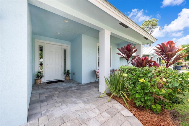 property entrance featuring stucco siding