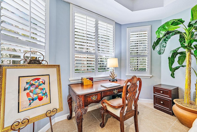 home office featuring light tile patterned flooring and baseboards