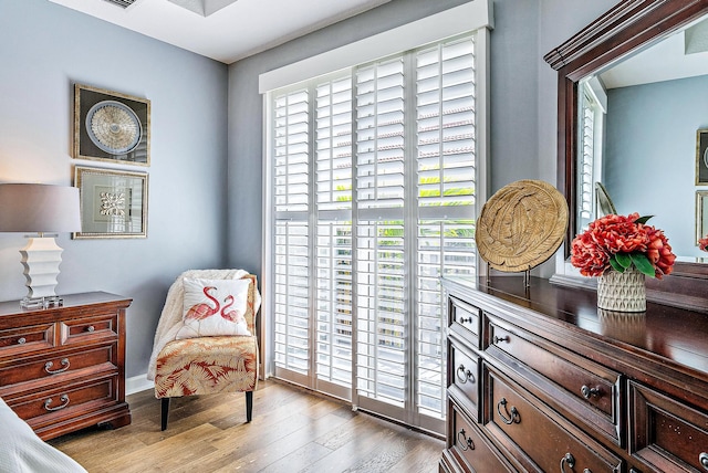 sitting room featuring a healthy amount of sunlight and wood finished floors