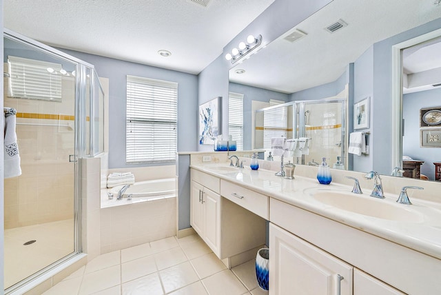 bathroom with visible vents, a sink, a shower stall, a bath, and tile patterned floors