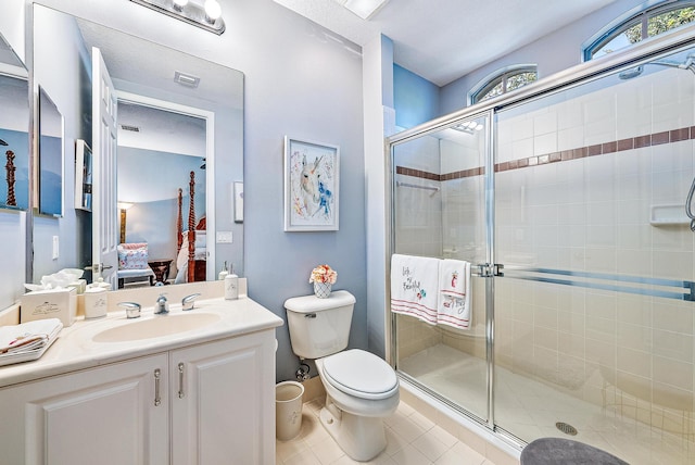 full bathroom featuring a stall shower, visible vents, toilet, tile patterned floors, and vanity