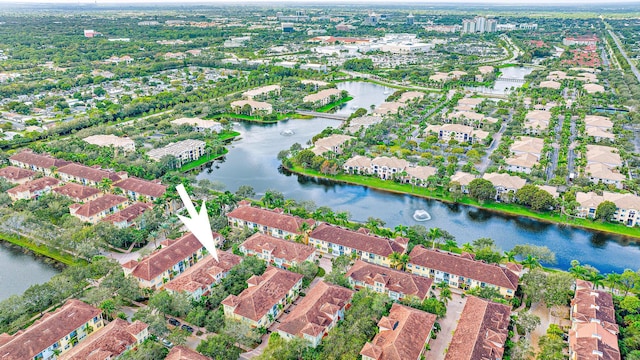 drone / aerial view featuring a residential view and a water view