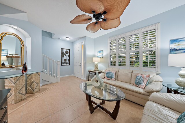 living room with a textured ceiling, tile patterned flooring, a ceiling fan, and baseboards