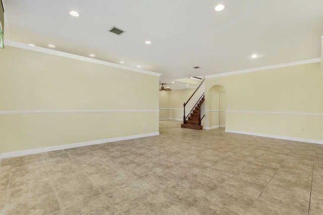 unfurnished room featuring baseboards, visible vents, arched walkways, stairway, and ornamental molding