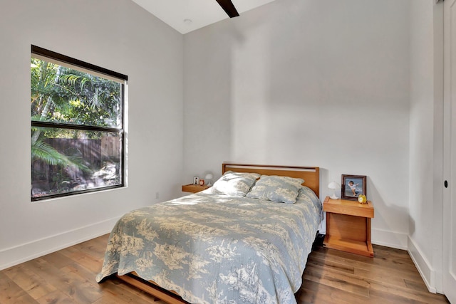 bedroom featuring ceiling fan, wood finished floors, and baseboards