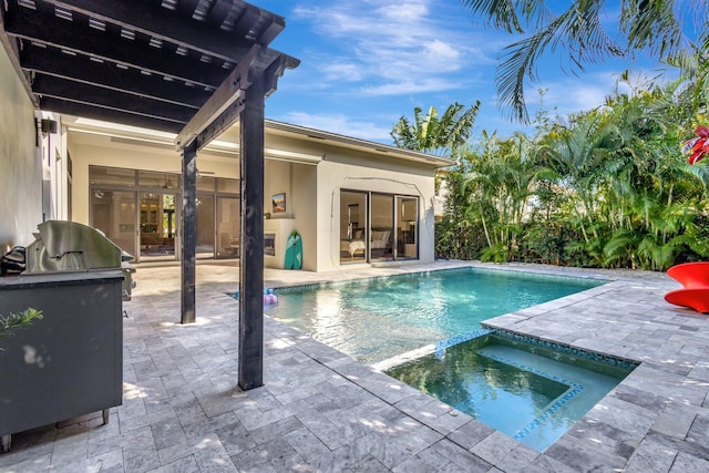 view of pool featuring a patio, area for grilling, and a pool with connected hot tub