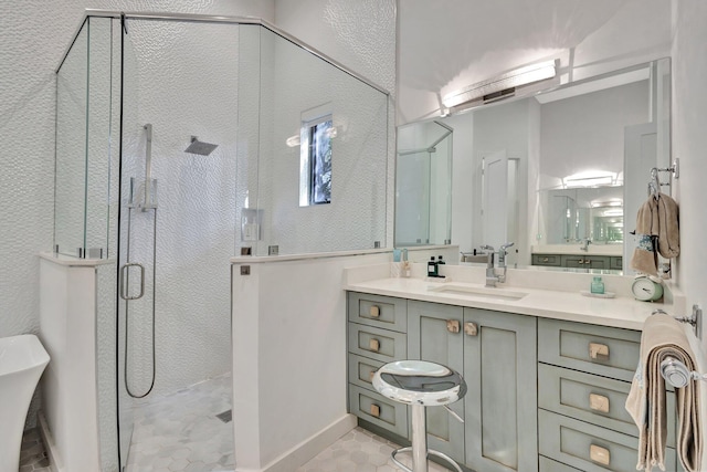 bathroom featuring a shower stall and vanity