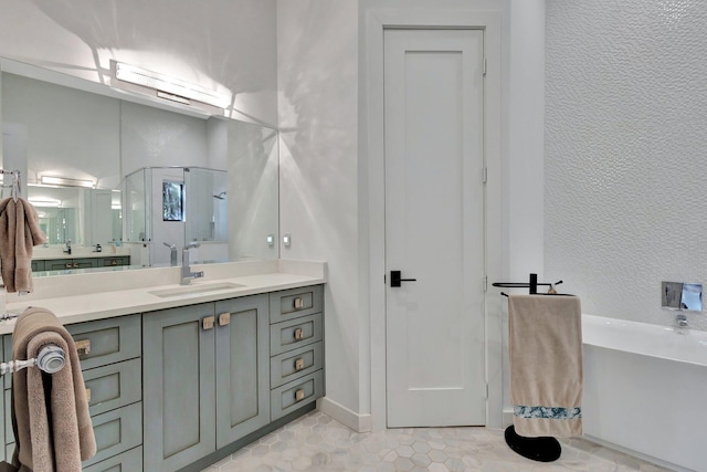 bathroom with a soaking tub, a textured wall, a stall shower, and vanity