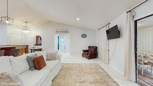living room with light tile patterned floors, lofted ceiling, a chandelier, and baseboards