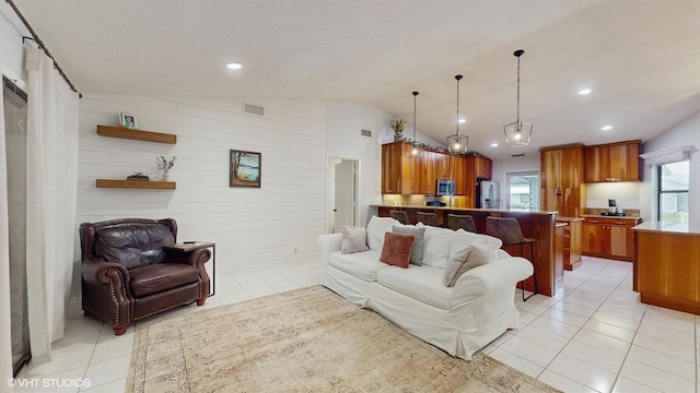living area featuring light tile patterned floors, vaulted ceiling, and recessed lighting