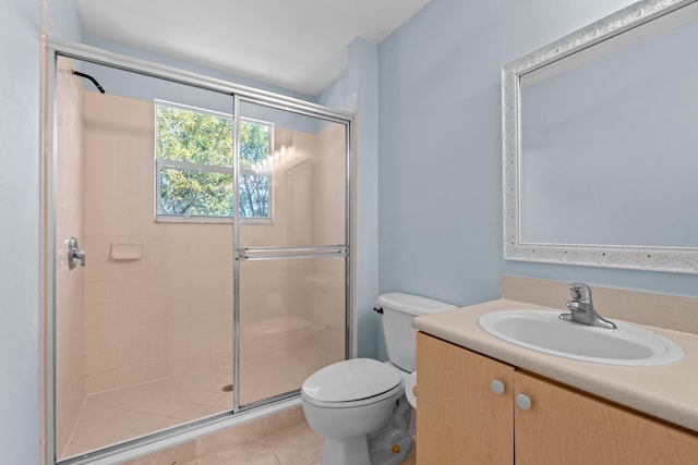 bathroom featuring toilet, a stall shower, tile patterned flooring, and vanity