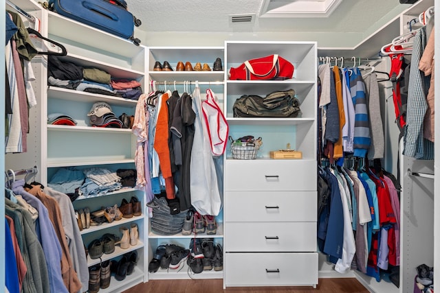 walk in closet with visible vents and wood finished floors