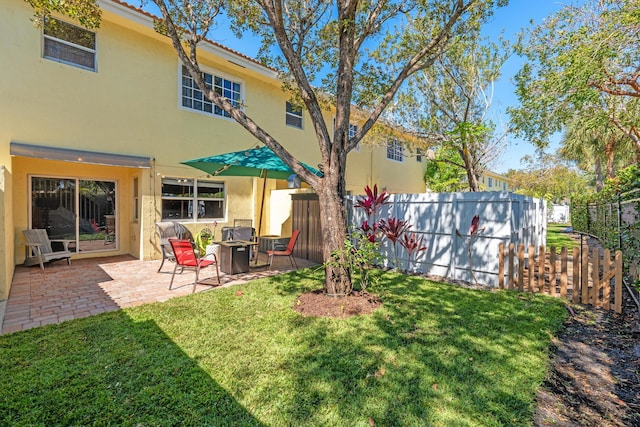 view of yard with fence and a patio